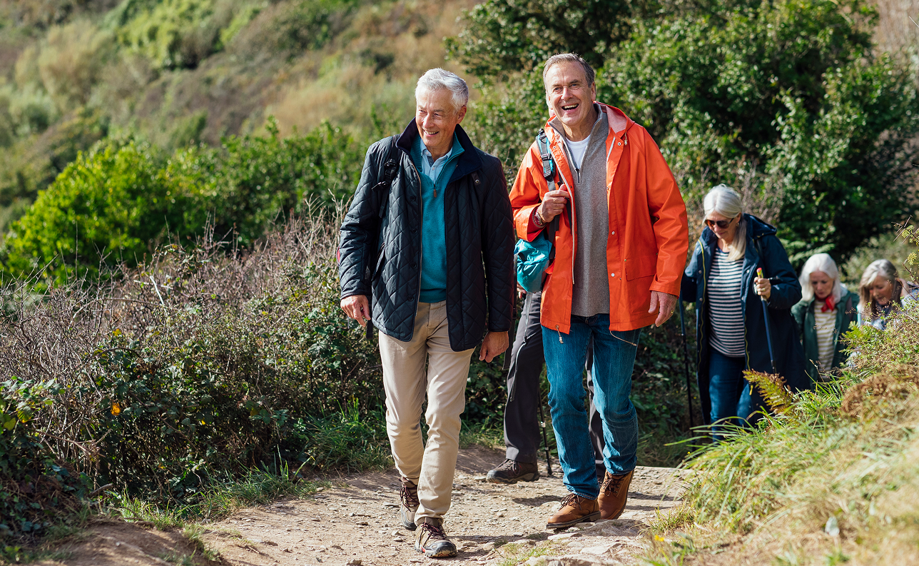 Two men at the front of a group of hikers following a trail