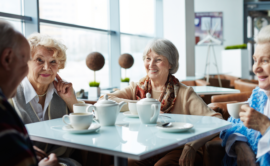 Old ladies sitting around a table drinking afternoon tea
